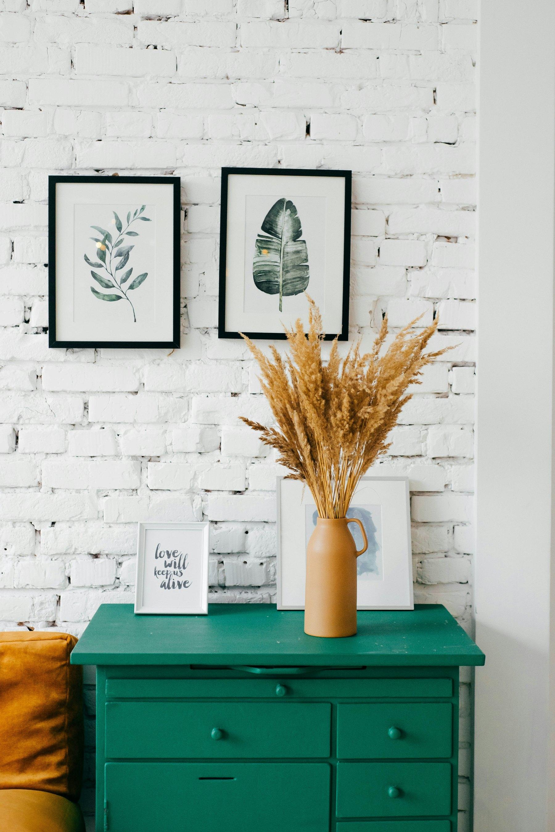 Green painted console with dried flowers